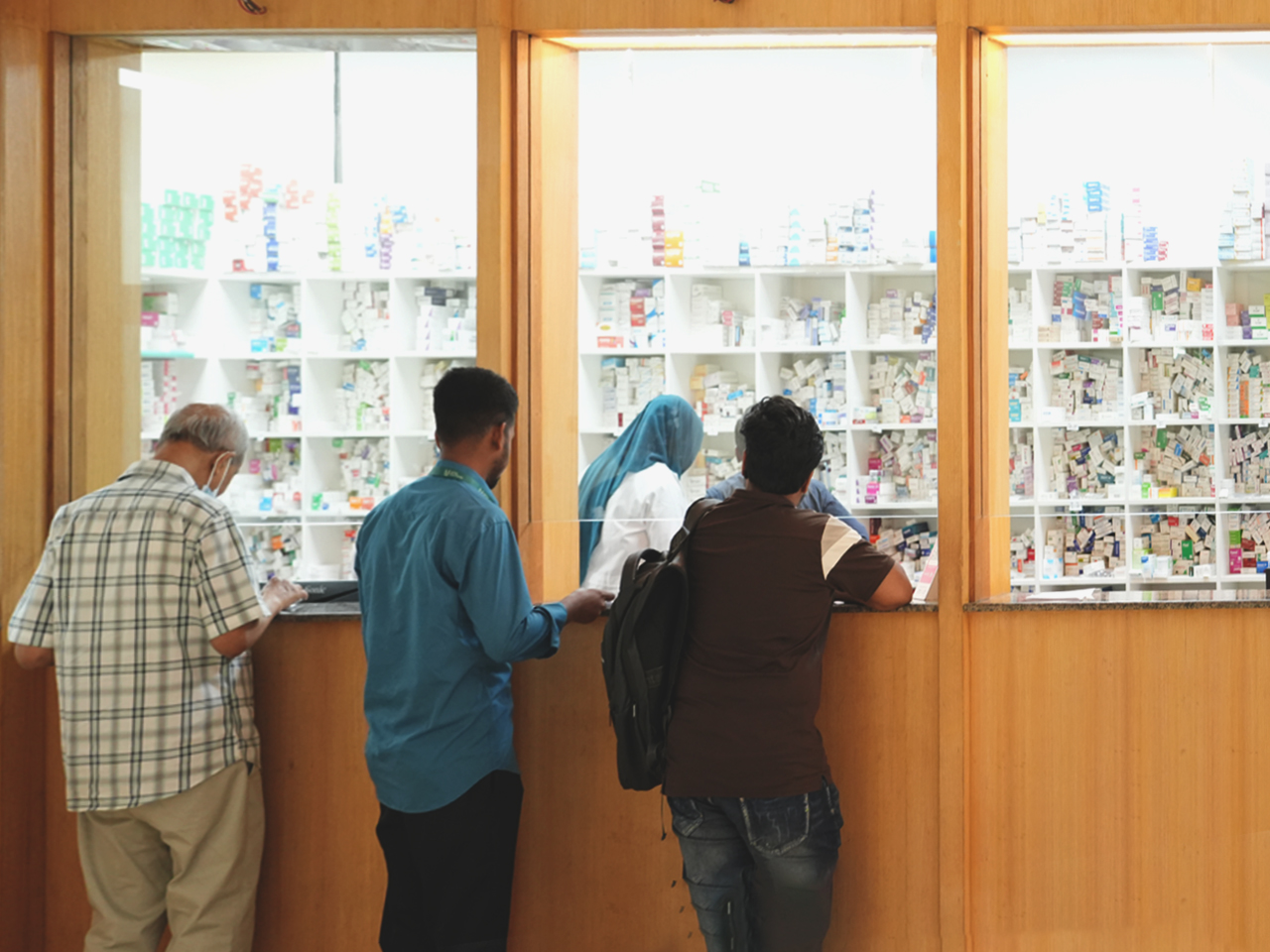 Pharmacist assisting a patient at the counter